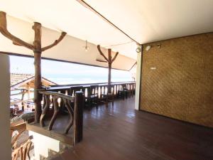 a dining room with tables and chairs in a building at Santai Surf Lodge-Balangan in Uluwatu