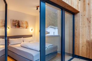 a room with a bed and a glass wall at Apartement Bens Auszeit Top 6 in Umhausen