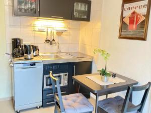 a small kitchen with a small table and a sink at Ferienwohnung Beyer Friedrichroda in Friedrichroda