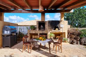 a patio with a table and a stone oven at Casa Tolo in Son Servera