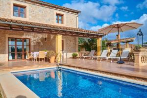 a villa with a swimming pool and a house at Casa Tolo in Son Servera