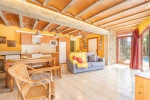 a kitchen and living room with a couch and a table at Cal Maso in Hostafranco