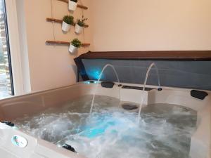 a jacuzzi tub with water coming out of it at Gîte Du Moulin De La Violaye in Fay-de-Bretagne +13 photos
