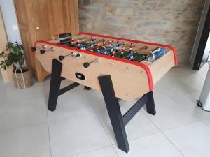 a wooden foosball table with a board on it at Gîte Du Moulin De La Violaye in Fay-de-Bretagne
