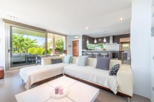 a living room with a large couch and a kitchen at Villa Zoe in Palma de Mallorca