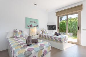 a bedroom with two beds and a window at Villa Zoe in Palma de Mallorca +16 photos