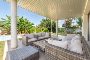 an outdoor patio with couches and a table at Villa Zoe in Palma de Mallorca