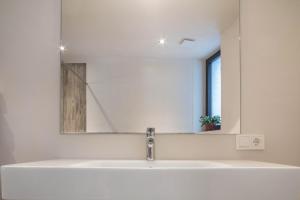 a bathroom with a sink and a mirror at Aumia Apartment Rubin in Völs am Schlern +17 photos
