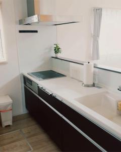 a kitchen with a sink and a counter top at Chigasaki Southern Beach House 茅ヶ崎サザンビーチハウス in Chigasaki