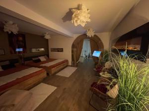 a hotel room with two beds and a laptop in it at Escape Private SPA I in Bad Zurzach