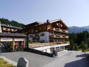 a large building with a parking lot in front of it at Panorama Chalet in Mittersill