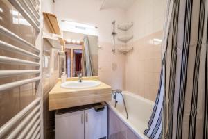 a bathroom with a sink and a bath tub at Appartement T3 Chatel in Châtel +17 photos
