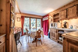 a kitchen and dining room with a table and chairs at Appartement T3 Chatel in Châtel