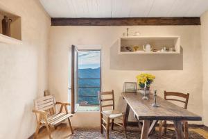 a dining room with a wooden table and chairs at Silent View - Unità 18 in Baiardo
