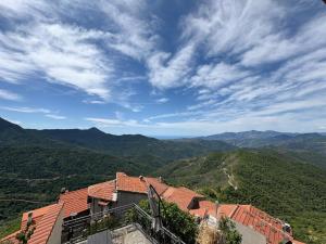 a view of a house with mountains in the background at Silent View - Unità 18 in Baiardo