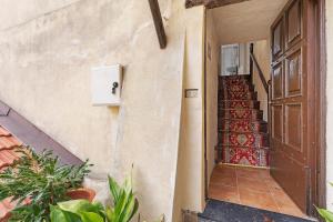 an entrance to a house with a door and a staircase at Silent View - Unità 18 in Baiardo