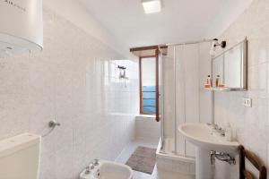 a white bathroom with a sink and a toilet at Silent View - Unità 18 in Baiardo
