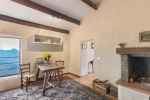 a dining room with a table and a fireplace at Silent View - Unità 18 in Baiardo +17 photos