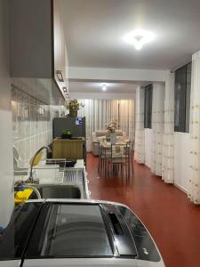 a kitchen with a sink and a table in a room at Minidepartamento en Huaral in Huaral