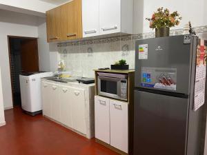 a kitchen with a refrigerator and a microwave at Minidepartamento en Huaral in Huaral