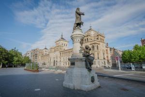 a statue in front of a large building at Mónaco in Valladolid