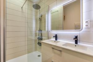 a bathroom with a sink and a mirror at Le Boumian in Saintes-Maries-de-la-Mer +20 photos