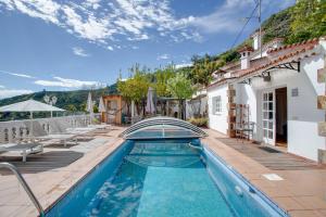 a villa with a swimming pool and a house at Villa Estanco 14 in Vega de San Mateo