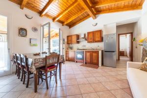 a kitchen and dining room with a table and chairs at Casa Vacanza Ghisu in SantʼAnna Arresi