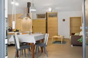 a kitchen and living room with a table and chairs at Maiglöckchen in Unterwittighausen +19 photos