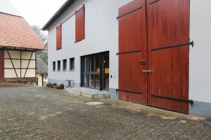 a building with two large wooden doors on it at Maiglöckchen in Unterwittighausen