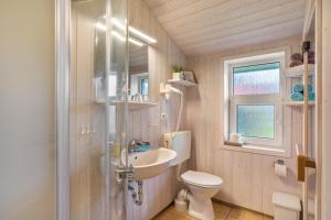a bathroom with a toilet and a sink and a shower at Skipper-Lodge West in Kosel +13 photos
