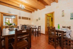 a dining room with wooden tables and chairs at Aldea Salguero in Albandi