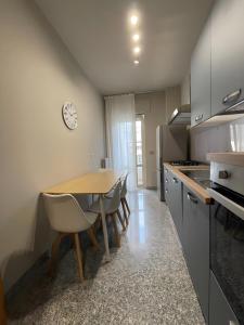 a kitchen with a table and chairs and a clock at Dimora Vibo Centro in Vibo Valentia +13 photos