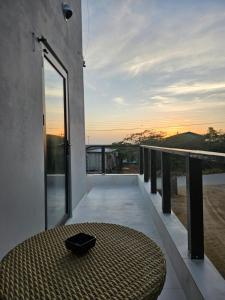 a balcony with a table and a view of the ocean at Happy stay297 in Paradera