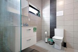 a bathroom with a white toilet and a window at Casa Caminho da Esperança in Porto Judeu +27 photos