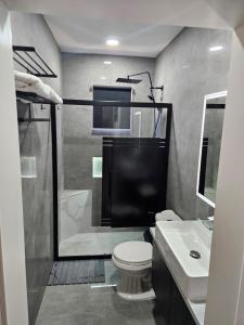 a bathroom with a shower and a toilet and a sink at Happy stay297 in Paradera +12 photos