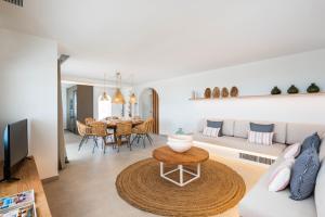 a living room with a couch and a table at Villa Atalis in Menorca