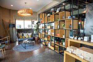 a room with a large book shelf filled with items at Sojourn Spa Hotel Kuala Lumpur in Kuala Lumpur