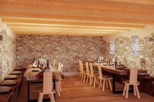 a dining room with a wooden table and chairs at Egger an der Lahn - Apt Wald in San Genesio Atesino +19 photos