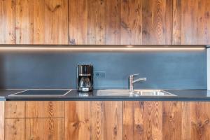 a kitchen counter with a sink and a coffee mug at Egger an der Lahn - Apt Wald in San Genesio Atesino