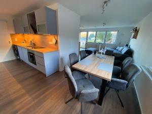 a kitchen and dining room with a table and chairs at Ferienwohnung am Waldesrand in Heringsdorf +16 photos