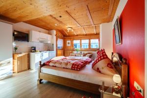 a bedroom with a large bed in a room at Pension Haus Rose in Oberharmersbach