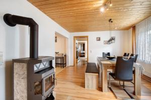 a wood stove in a living room with a table at Ferienwohnung Annette in Gomadingen