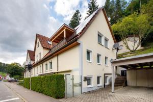 a white house with a brown roof at Ferienwohnung Annette in Gomadingen