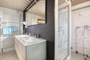 a bathroom with a sink and a shower at Ferienwohnung Annette in Gomadingen +21 photos