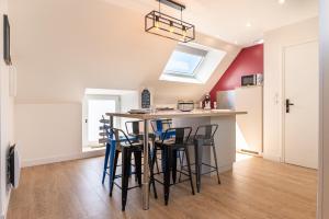 a kitchen with a table and chairs in a room at Traou Mad in Merlevenez +13 photos