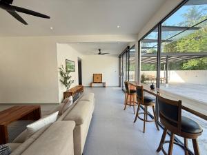 a living room with a couch and chairs at Mujito4 16PAX 4BR 1 Min To ECM KCM, BBQ PIT, PS4, Netflix in Kuantan