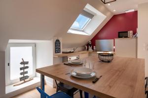 a kitchen and dining room with a wooden table at Traou Mad in Merlevenez