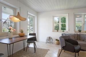a living room with a table and a couch at Karlotta in Eriskirch