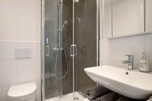 a bathroom with a shower and a sink and a toilet at Karlotta in Eriskirch +13 photos